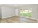 Bright living room featuring fresh gray paint, large windows, and modern vinyl plank flooring at 7643 S Delaware St, Indianapolis, IN 46227
