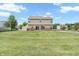 Expansive lawn area with a two-story home featuring neutral siding, vinyl windows, and a backyard shed at 793 Penny Ln, Pittsboro, IN 46167