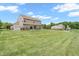 Spacious backyard featuring a large lawn, sliding glass doors, vinyl siding, and mature trees at 793 Penny Ln, Pittsboro, IN 46167