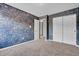 Carpeted bedroom with textured blue accent wall, single window, and closet at 793 Penny Ln, Pittsboro, IN 46167