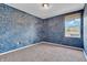 Carpeted bedroom with textured blue accent wall, single window, and white trim at 793 Penny Ln, Pittsboro, IN 46167