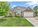 Charming two-story home featuring a brick and vinyl exterior, manicured lawn, and attached two-car garage at 793 Penny Ln, Pittsboro, IN 46167