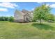Two-story home with brick accents, neutral siding, manicured lawn, and mature trees at 793 Penny Ln, Pittsboro, IN 46167