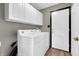Bright laundry room with washer, dryer and overhead storage for convenience at 793 Penny Ln, Pittsboro, IN 46167