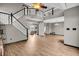 Open-concept living room with a staircase, high ceilings, and modern flooring at 793 Penny Ln, Pittsboro, IN 46167
