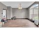Unfurnished living room highlighting the window, light fixture, and modern flooring at 793 Penny Ln, Pittsboro, IN 46167