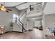 Bright, open living area with a staircase, high ceilings, and modern flooring at 793 Penny Ln, Pittsboro, IN 46167