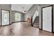 An open living room featuring wood floors, a staircase, and an abundance of natural light at 793 Penny Ln, Pittsboro, IN 46167