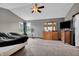 Spacious primary bedroom with ceiling fan, large windows, and comfortable carpeting at 793 Penny Ln, Pittsboro, IN 46167