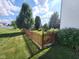 Spacious backyard featuring a well-maintained lawn, privacy fence, and mature trees at 8433 Vyners Ln, Avon, IN 46123