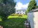Well-maintained backyard with mature trees, a pergola patio, and a storage shed at 8433 Vyners Ln, Avon, IN 46123