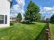 View of the large backyard, pergola, wooden fence, and lush landscaping at 8433 Vyners Ln, Avon, IN 46123