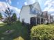Two-story home with vinyl siding featuring black window shutters and a covered front porch at 8433 Vyners Ln, Avon, IN 46123