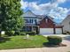 Charming two-story home featuring a well-maintained lawn, lush landscaping, and a welcoming curb appeal at 8433 Vyners Ln, Avon, IN 46123