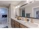 Modern bathroom with double vanity, sleek countertops, and access to a walk-in closet at 9124 Anthem Ave, Plainfield, IN 46168