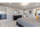 Spacious bedroom with a modern aesthetic, featuring a dresser, decor, and soft natural light at 9124 Anthem Ave, Plainfield, IN 46168