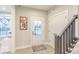 Bright entryway with modern decor, stylish front door, closet, and stairs leading to the upper level at 9124 Anthem Ave, Plainfield, IN 46168