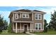 Charming two-story home with tan siding, white trim, covered porch, and well-manicured landscaping at 9124 Anthem Ave, Plainfield, IN 46168