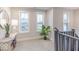 Bright hallway with large windows, neutral carpet, stylish decor, and modern finishes at 9124 Anthem Ave, Plainfield, IN 46168