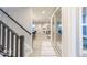 Inviting hallway with light wood floors, staircase, and sliding glass doors leading to the backyard at 9124 Anthem Ave, Plainfield, IN 46168
