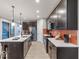 Spacious kitchen has stainless appliances, a center island with seating, and plenty of counter space at 9124 Anthem Ave, Plainfield, IN 46168
