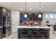 Bright kitchen boasts a spacious island, stainless appliances, and stylish tile backsplash at 9124 Anthem Ave, Plainfield, IN 46168