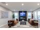 Modern living room with comfortable seating, a fireplace, a large television, and plenty of natural light at 9124 Anthem Ave, Plainfield, IN 46168
