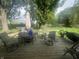 Inviting backyard deck featuring outdoor seating, a trampoline, and a lush green lawn perfect for entertaining at 9783 Lee Ct, Columbus, IN 47203