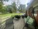 A spacious wooden deck features a grill, seating, and a swing, ideal for outdoor relaxation and gatherings at 9783 Lee Ct, Columbus, IN 47203