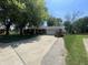 Brick ranch style home with a long driveway and a well-maintained front yard and mature trees at 9783 Lee Ct, Columbus, IN 47203