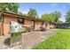 Brick home's backyard featuring a concrete patio, grill, and outdoor seating at 3331 Loral Dr, Anderson, IN 46013