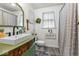 Bathroom with a stylish vanity, modern fixtures, and a shower-curtained tub at 3331 Loral Dr, Anderson, IN 46013