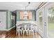 Inviting dining room with wood floors, white wainscoting, and a modern chandelier at 3331 Loral Dr, Anderson, IN 46013