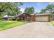 A brick home featuring a wide driveway and an attached two-car garage, set back from the street at 3331 Loral Dr, Anderson, IN 46013