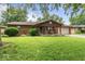 Charming single-story brick home with a well-manicured lawn and a cozy front porch at 3331 Loral Dr, Anderson, IN 46013