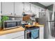 Well-lit kitchen with stainless steel appliances, light cabinets, and butcher block countertops at 3331 Loral Dr, Anderson, IN 46013