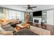 Relaxing living room with a large sofa, fireplace, and hardwood floors, perfect for entertaining at 3331 Loral Dr, Anderson, IN 46013