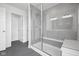 Bathroom featuring a large glass-enclosed shower with a seat and grey tile at 3980 Canning St, Danville, IN 46122