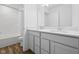Bathroom with double sinks, white cabinets and quartz countertops, and shower-tub combo at 3980 Canning St, Danville, IN 46122