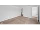 This is a view of a large bedroom with neutral carpeting and an open closet space at 3980 Canning St, Danville, IN 46122