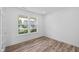 Bright bedroom with two windows, neutral walls, and sleek hardwood flooring at 3980 Canning St, Danville, IN 46122