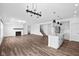 Open-concept space featuring a kitchen with an island, a cozy fireplace, and beautiful hardwood flooring at 3980 Canning St, Danville, IN 46122