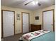 Bedroom showcasing a neatly made bed and multiple closet doors for ample storage at 951 Plaza W Dr # 7B, Martinsville, IN 46151