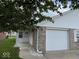 Exterior view of attached garage with walkway to covered entry at 951 Plaza W Dr # 7B, Martinsville, IN 46151