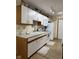 Traditional kitchen with white appliances, ample counter space, and wood-look flooring at 951 Plaza W Dr # 7B, Martinsville, IN 46151