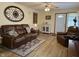 Living room featuring laminate floors, leather furniture, and front door at 951 Plaza W Dr # 7B, Martinsville, IN 46151