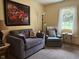 Comfortable living room showcasing a soft gray loveseat and a cozy reading chair at 951 Plaza W Dr # 7B, Martinsville, IN 46151