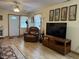 Comfortable living room features laminate floors and natural light at 951 Plaza W Dr # 7B, Martinsville, IN 46151