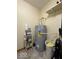 Utility room featuring a water heater, storage shelves, and tile flooring at 951 Plaza W Dr # 7B, Martinsville, IN 46151
