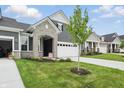 Attractive home featuring stone accents, neutral siding, a two car garage and well maintained lawn at 16969 Cole Evans Dr, Noblesville, IN 46060